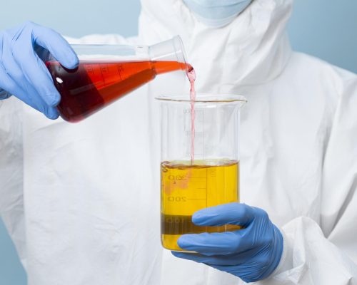 front-view-scientist-mixing-different-chemicals front-view-scientist-mixing-different-chemicals